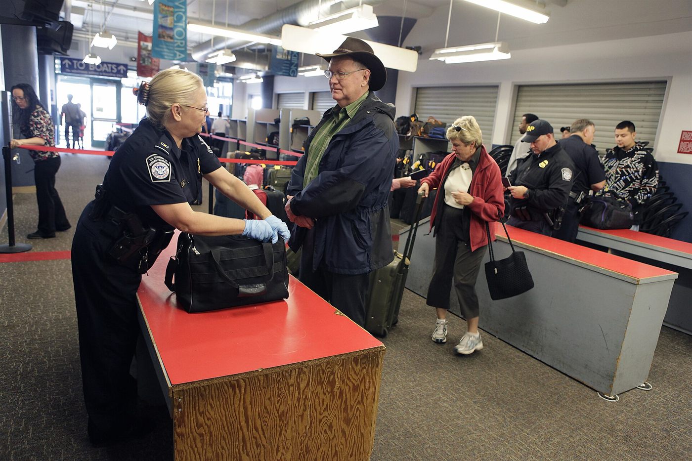 Customs officer physically inspecting a consignment at a port of entry