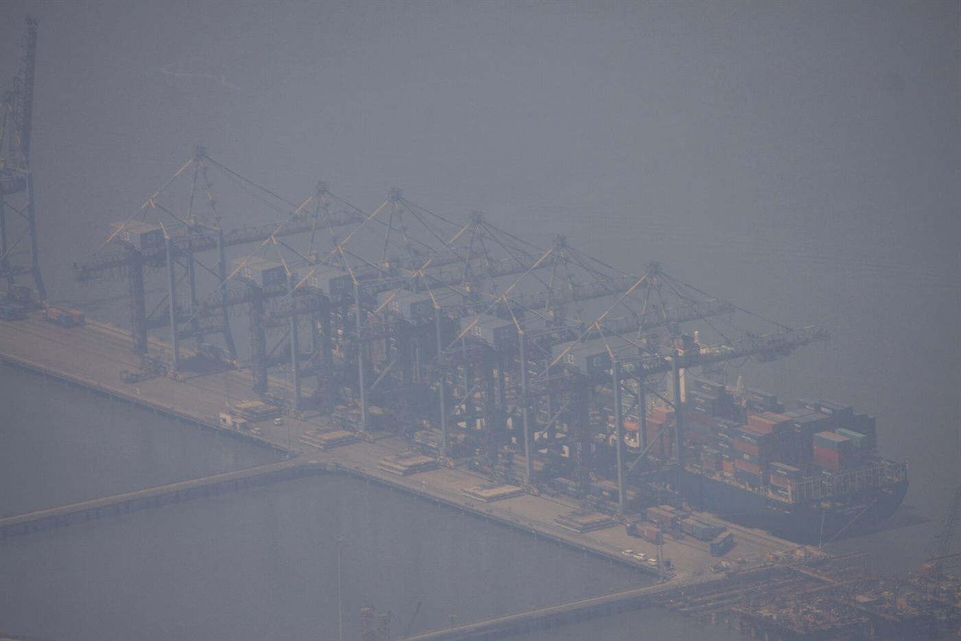 Large container ship berthed at Mumbai with containers stacked on deck